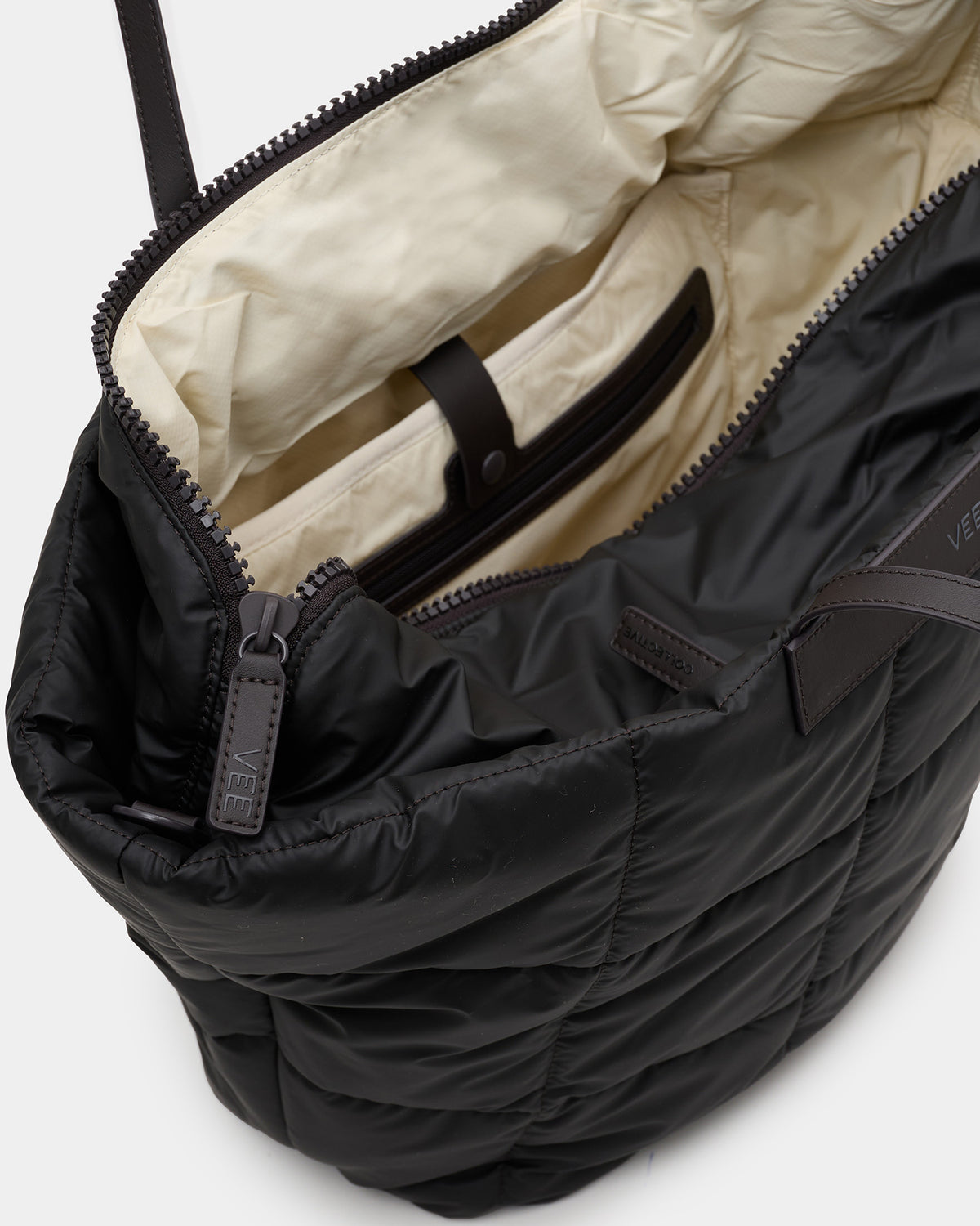 Close-up view of a Porter Marche bag with its zipper open, showcasing the beige interior lining against a clean white background.