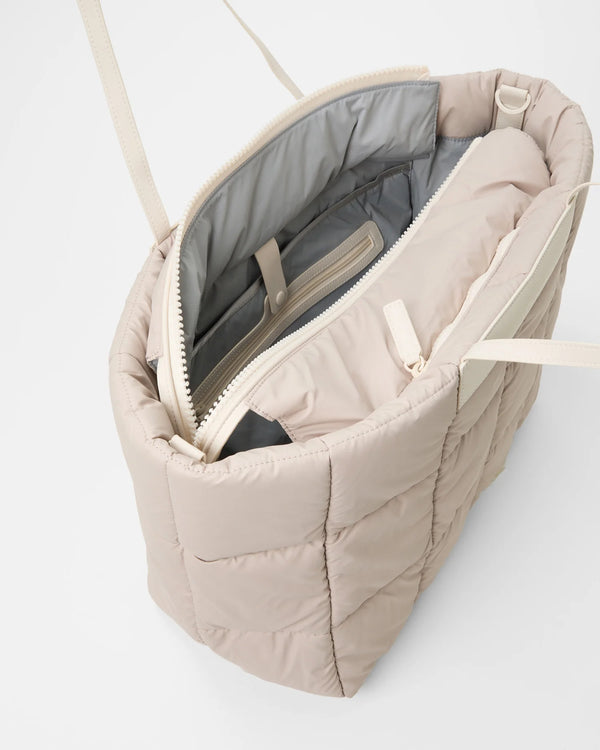 Open Vee Collective Porter Marché Large in Soft Taupe, showing the quilted exterior, top zipper, and interior compartments of the tote bag.