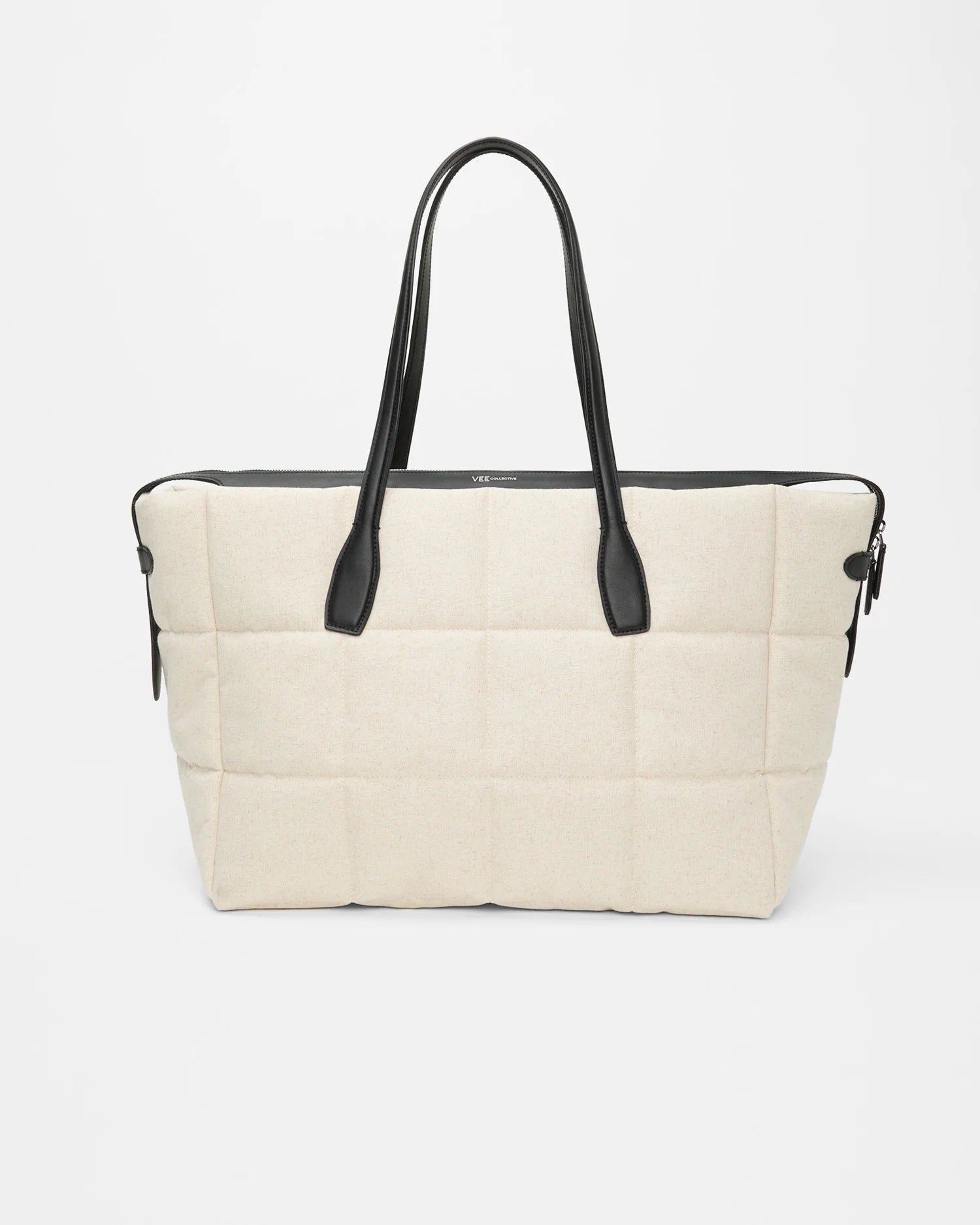 Large Tela Tote in natural canvas with black leather handles worn by a model