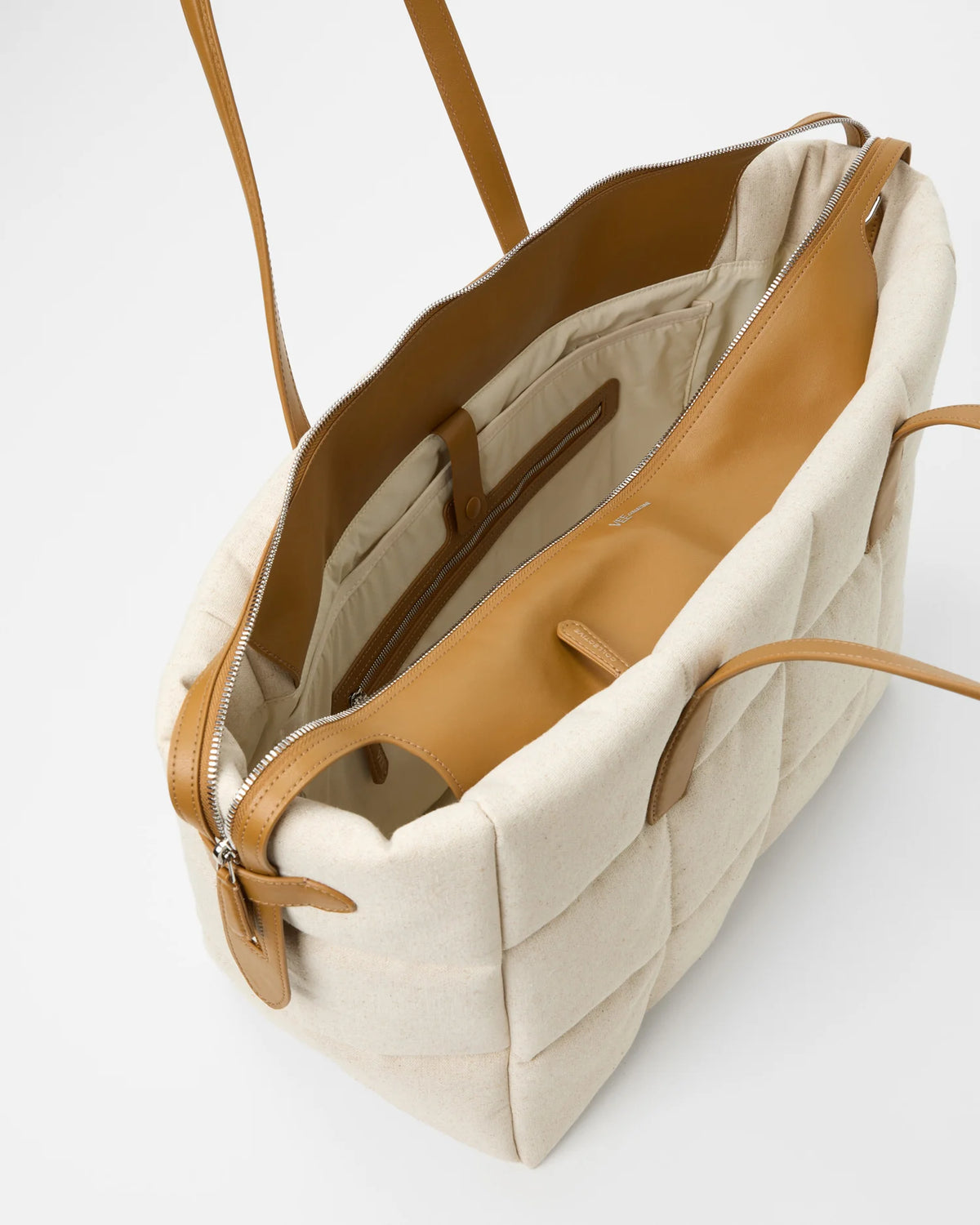 Inside view of Tela Tote showing tan leather trim and organized pockets