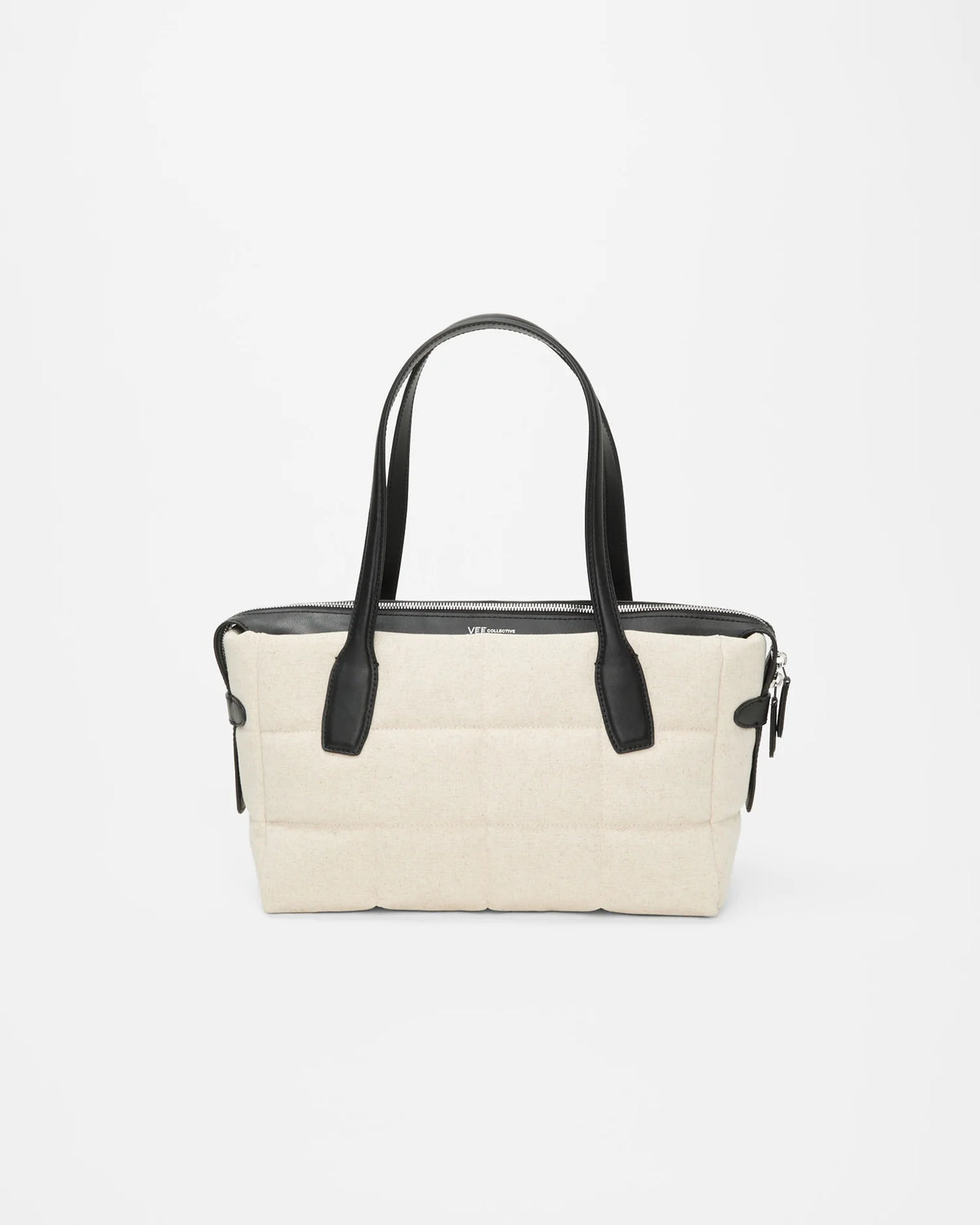 Tela Tote Small Natural canvas bag with black leather handles and a top zipper.