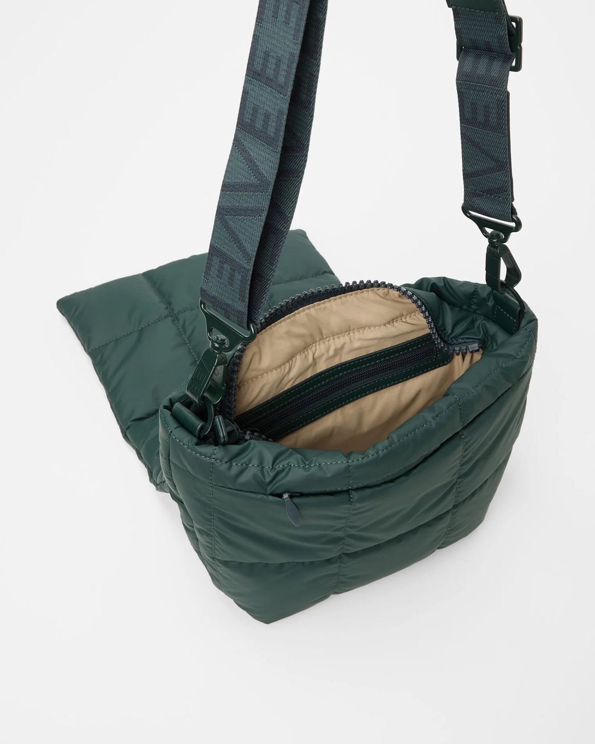 Angled product photo of the Porter Messenger Bag in bottle green by Vee Collective, shown open.