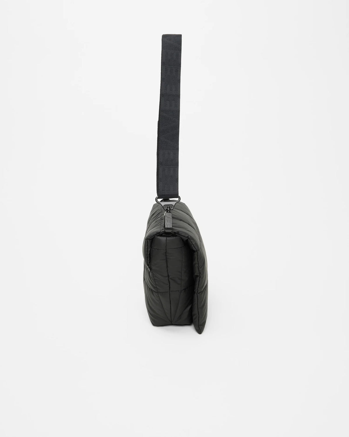 Side view product photo of the Porter Messenger Bag in matt black by Vee Collective, shown closed, designed as a crossbody bag.