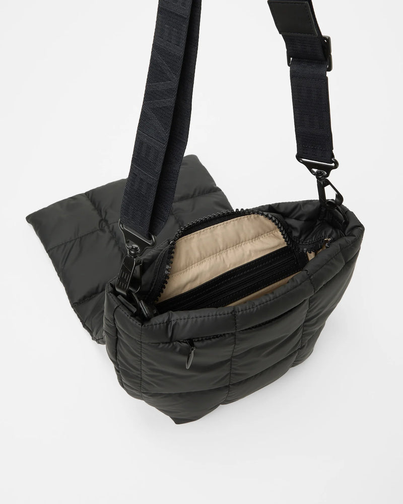 Angled product photo of the Porter Messenger Bag in matt black by Vee Collective, shown open.
