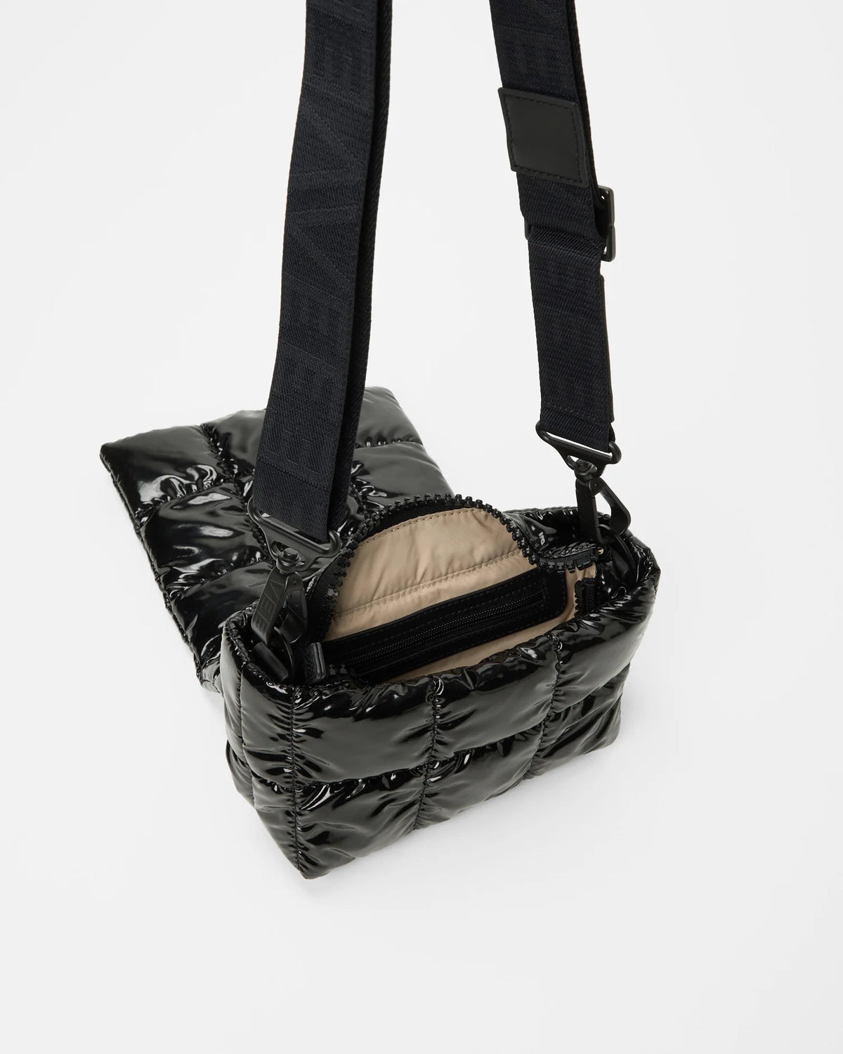 Angled product photo of the Porter Messenger Mini Bag in black vinyl by Vee Collective, shown open.