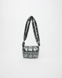 Full view of the grey metallic Gadget Messenger bag with long straps raised into an arch against a light background