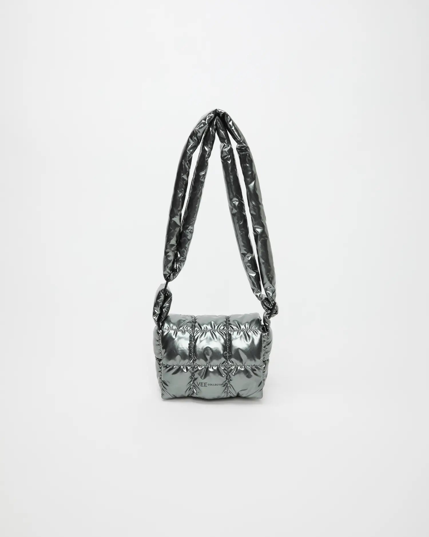 Full view of the grey metallic Gadget Messenger bag with long straps raised into an arch against a light background