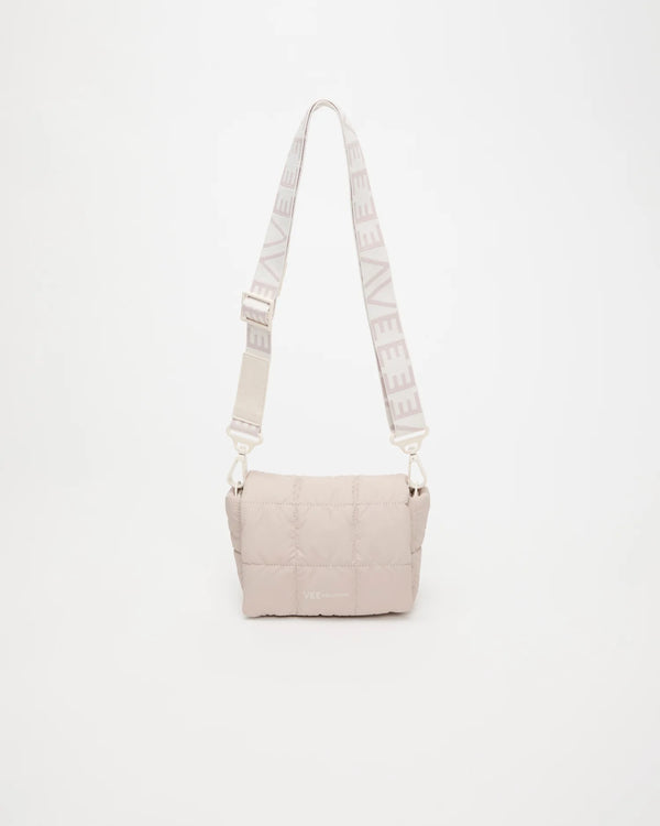 Front view of the Porter Messenger Mini Bag in Barely Beige by Vee Collective, displayed with its strap.