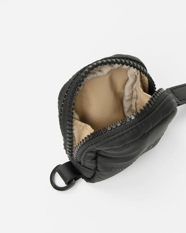 Product photo of the Porter Pods Case in matt black, shown slightly angled with the lid open to reveal its brown interior lining.