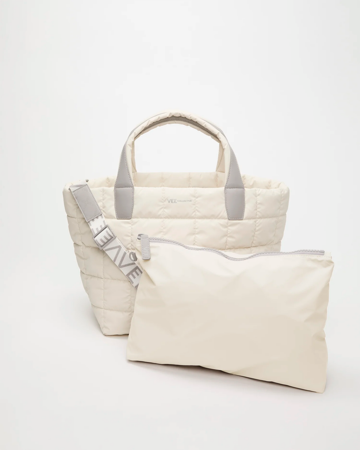 Front view of the Vee Collective Porter Tote Bag Medium in Barely Beige, shown with a matching pouch and detachable shoulder strap.