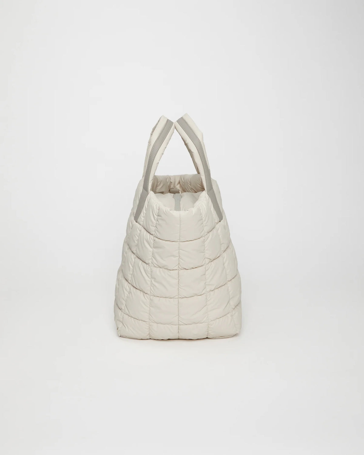 Side view product image of the Porter Tote Medium Bag in Barely Beige by Vee Collective.