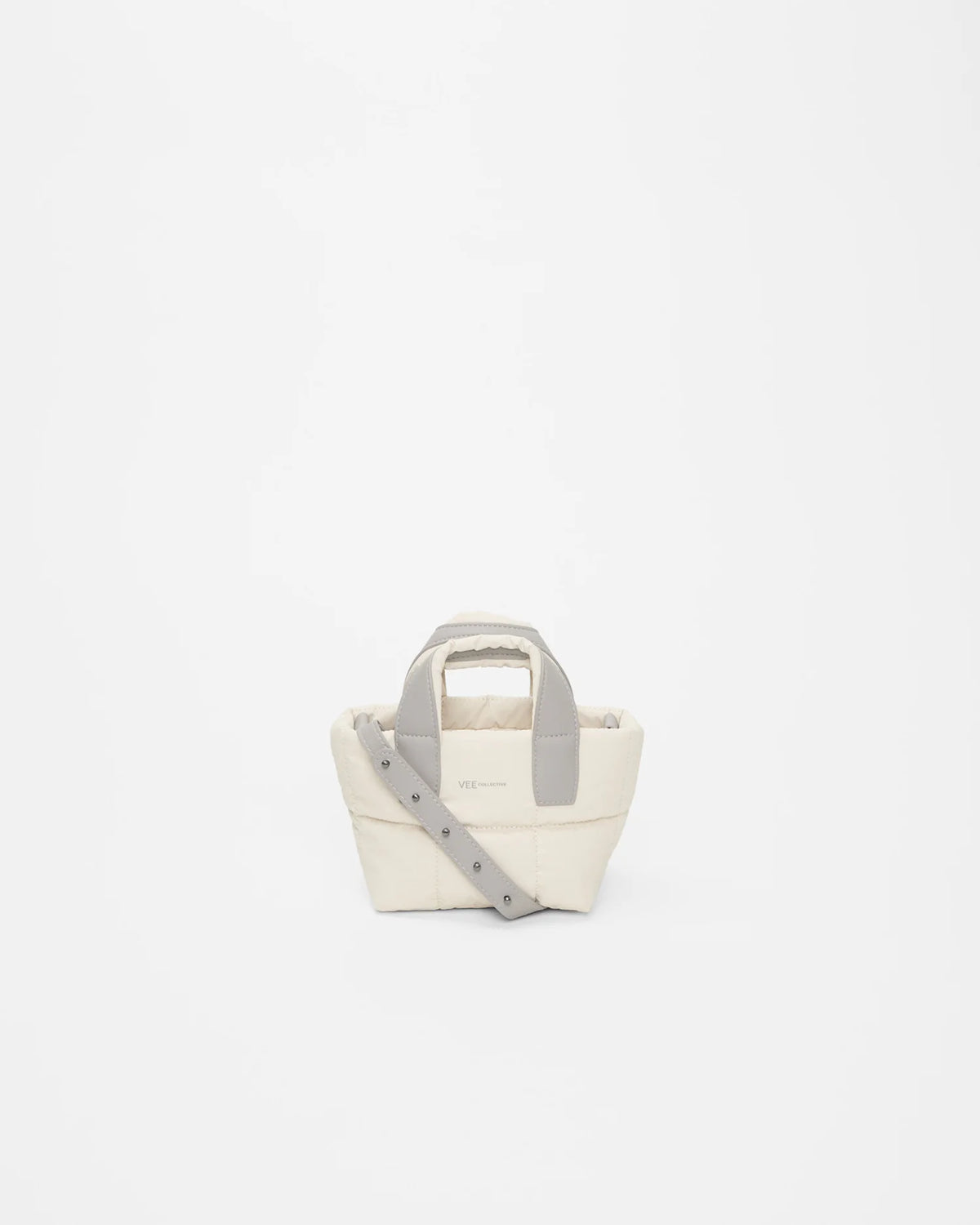 Front view of the Porter Tote Bag Micro in Barely Beige by Vee Collective, displayed with its strap.