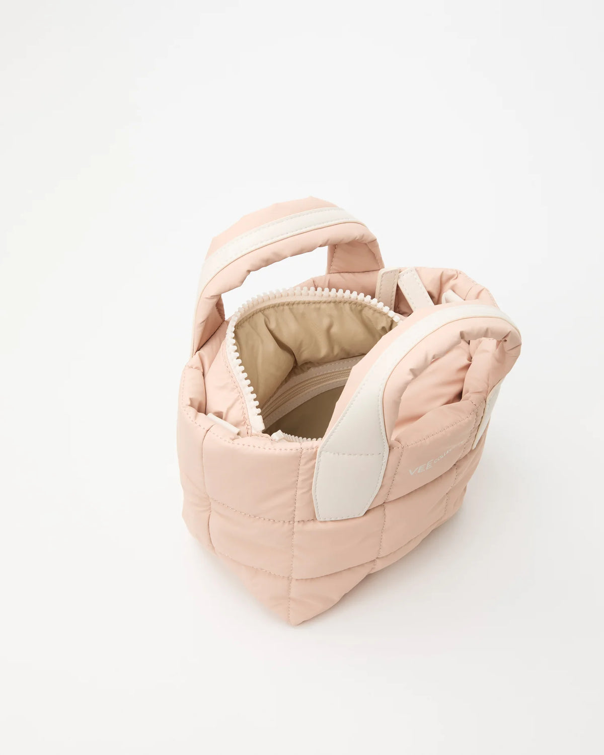 Open Vee Collective Porter Tote Bag Mini in Cameo Rose, showing the quilted exterior, top zipper, and interior compartments of the tote bag.