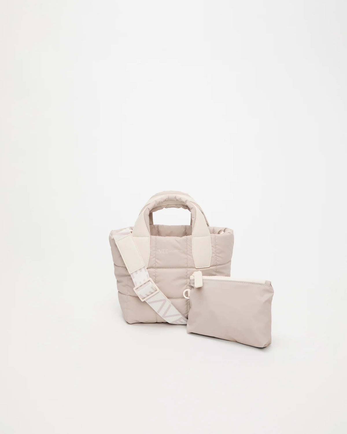 Front view of the Vee Collective Porter Tote Mini in Soft Taupe with matching pouch and detachable strap.