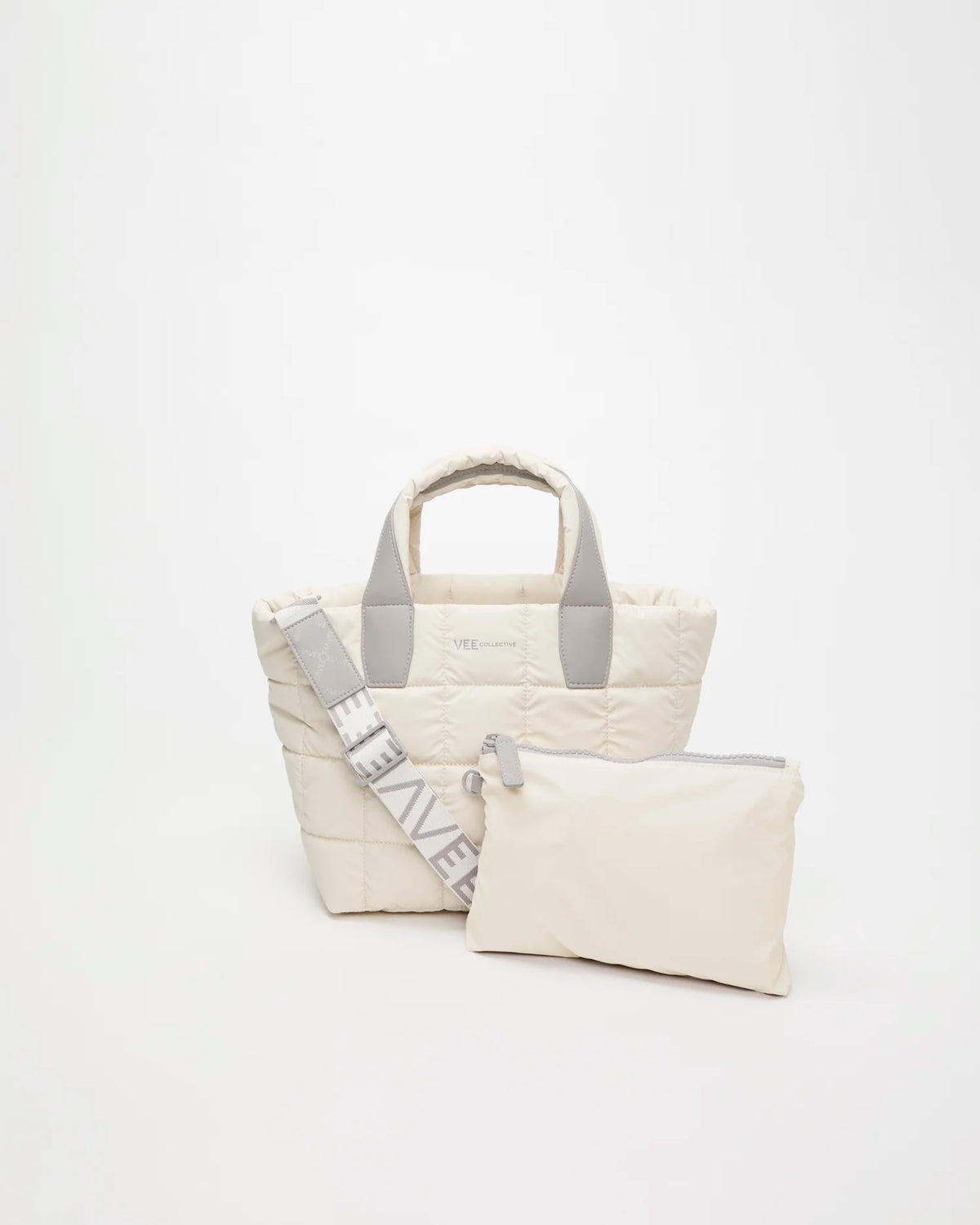 Front view of the Vee Collective Porter Tote Bag Small in Barely Beige, shown with a matching pouch and detachable shoulder strap.