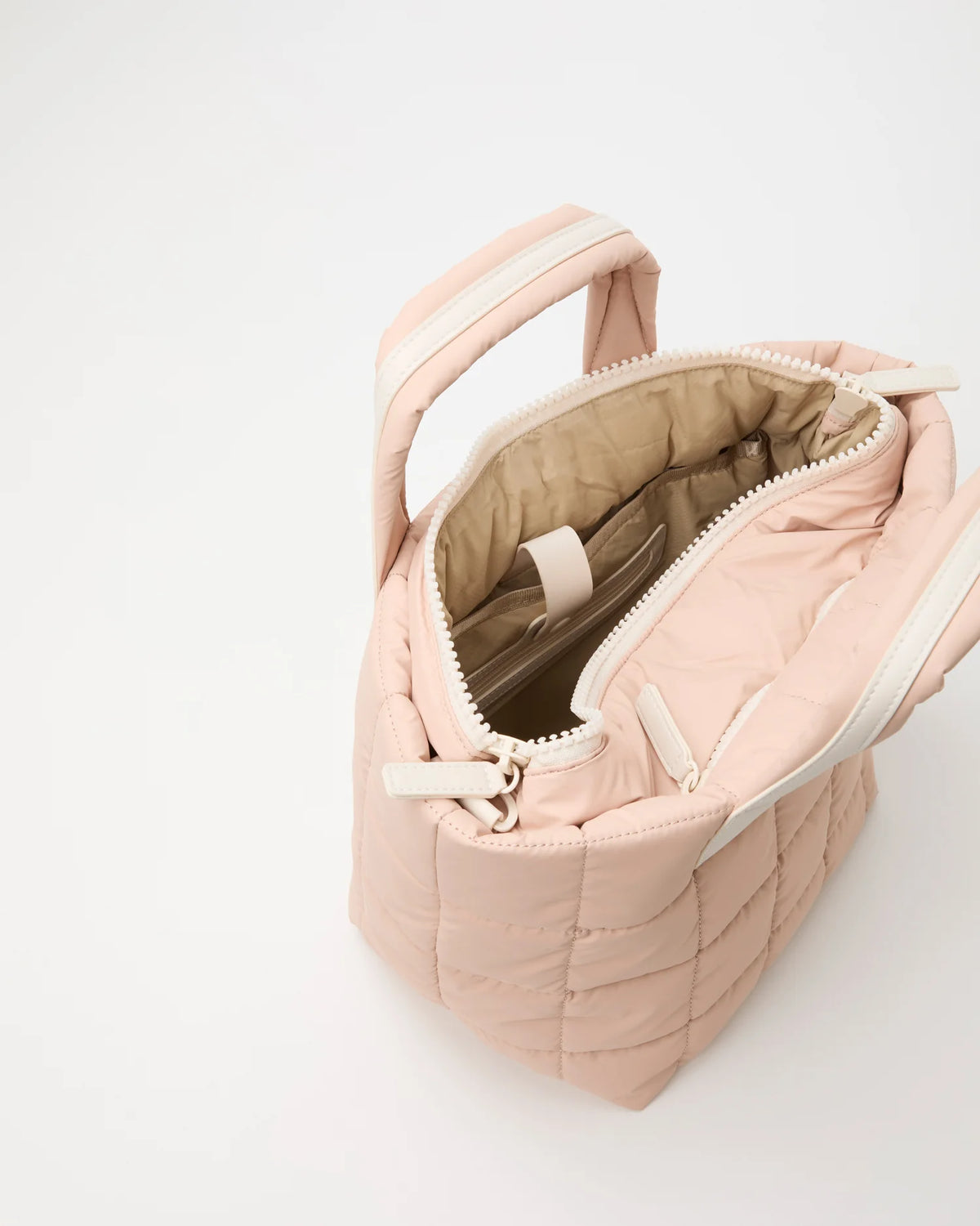 Open Vee Collective Porter Tote Bag Small in Cameo Rose, showing the quilted exterior, top zipper, and interior compartments of the tote bag.