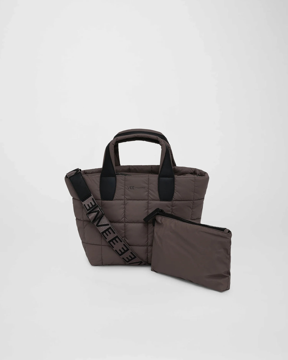 A small, quilted tote bag in a soft mink color features sturdy black handles and a removable shoulder strap. It includes a matching zippered pouch, perfect for organizing essentials, and showcases a stylish, puffy square pattern.