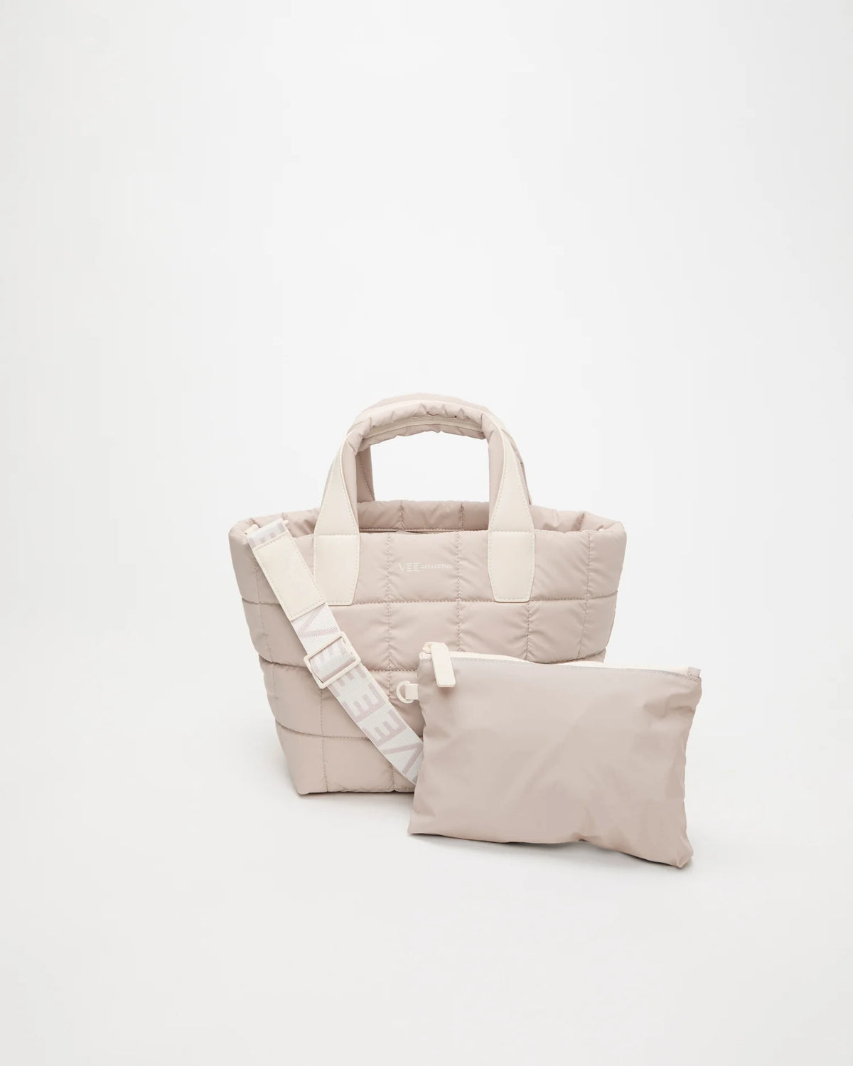 Front view of the Vee Collective Porter Tote Small in Soft Taupe with matching pouch and detachable strap.