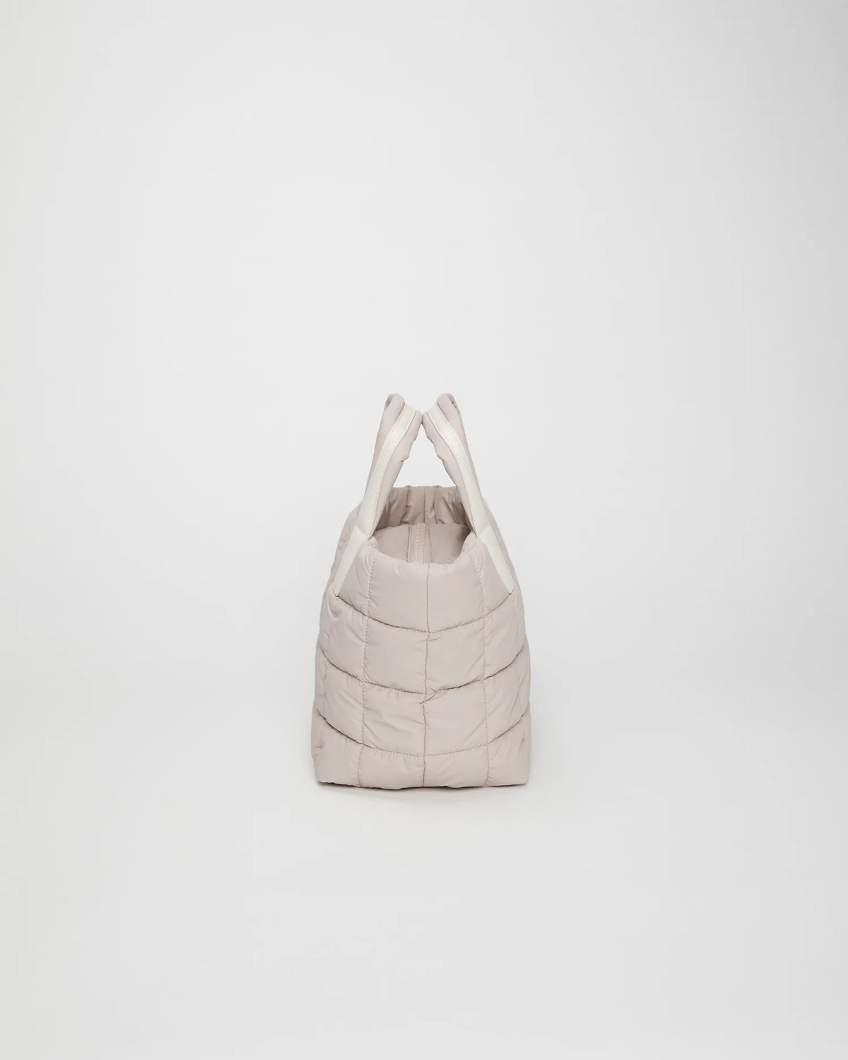 Side view product image of the Porter Tote Small Bag in Soft Taupe by Vee Collective.