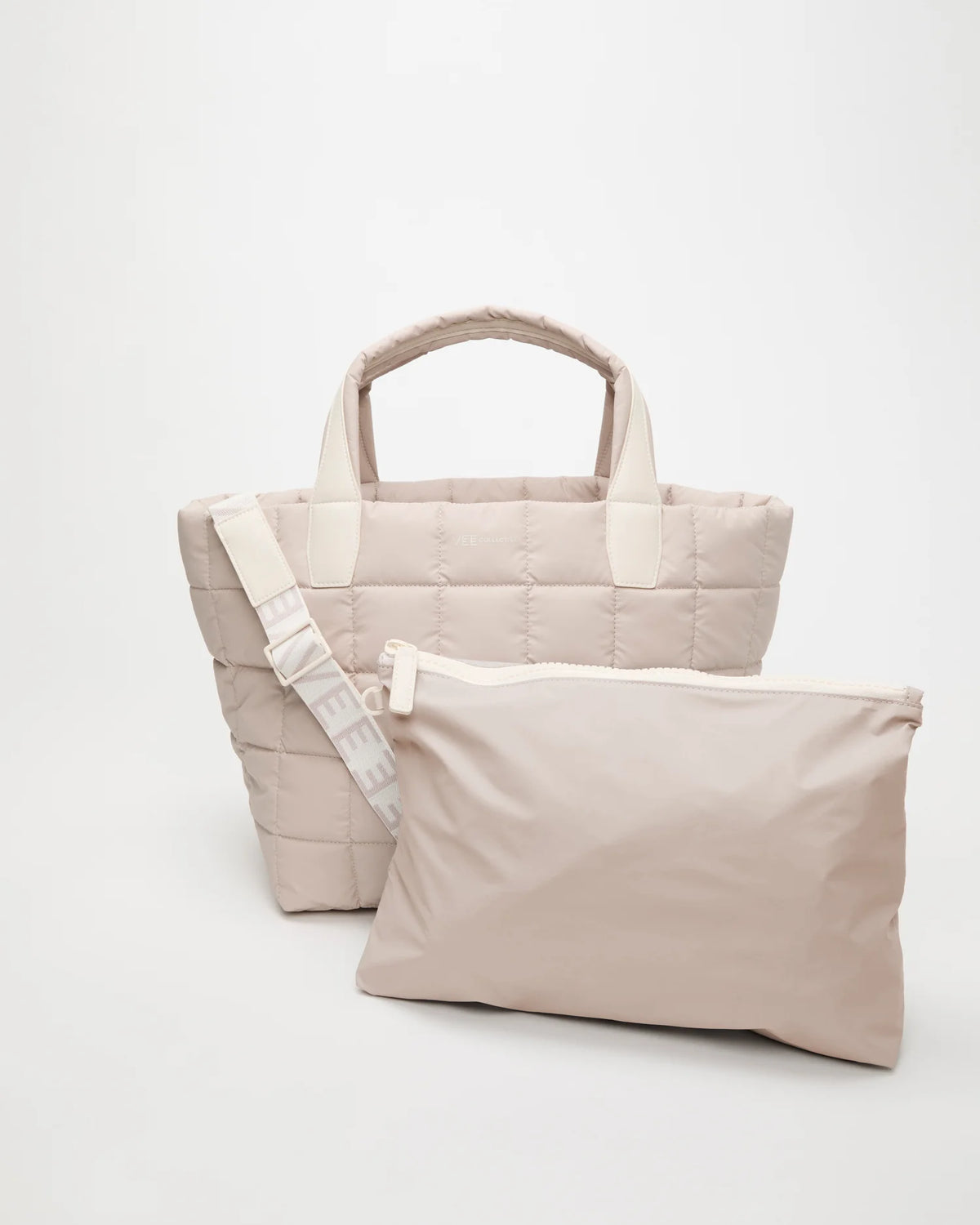 Front view of the Vee Collective Porter Tote Medium in Soft Taupe with matching pouch and detachable strap.