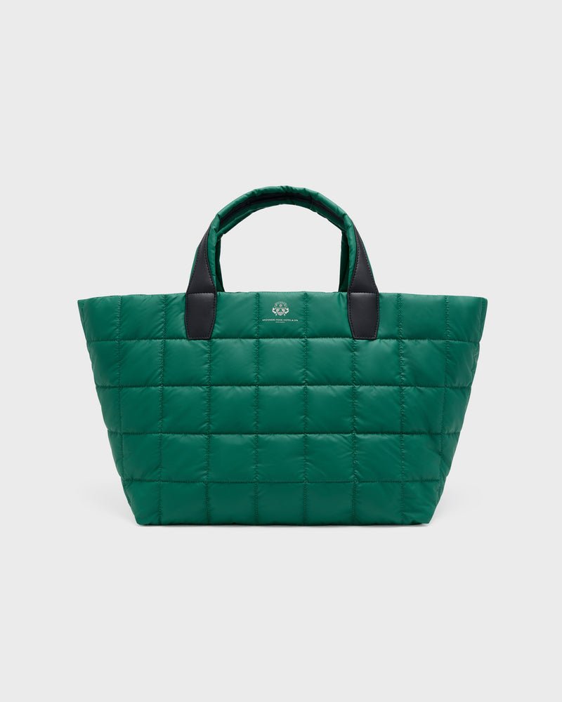 A green quilted puffer tote bag with black handles and a small silver logo on the front, photographed against a light gray background.
