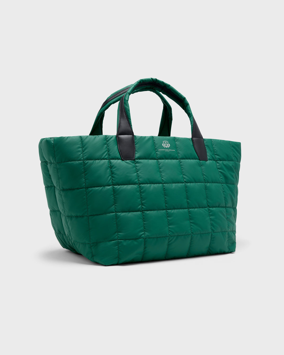 A green quilted puffer tote bag with black handles and a small white logo on the front, set against a light gray background.