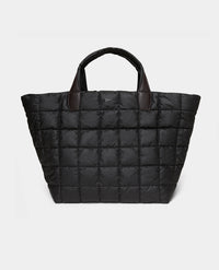 The Porter Weekender bag espresso quilted puffer tote bag with dark brown leather handles, shown against a white background.
