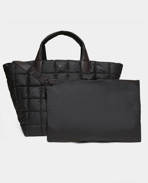 The porter weekender bag in espresso with dark brown handles, shown alongside a matching black nylon zippered pouch on a lwhite background.
