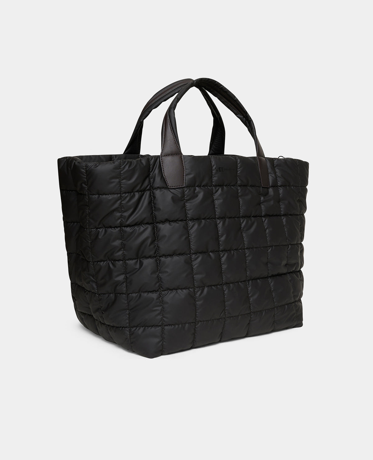 The  Porter weekender   espresso bag with brown handles, shown open and filled with travel items including a water bottle, cup, and small accessories. A plaid zip pouch and white sneakers are placed beside it on a white background.