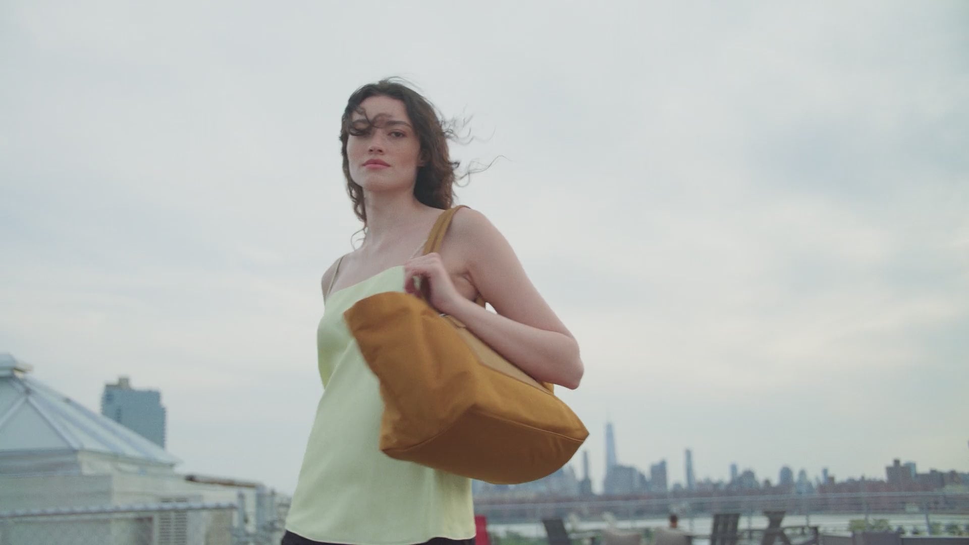 A video featuring a model walking through the city while carrying the Vee TA Anderson collaboration bag.
