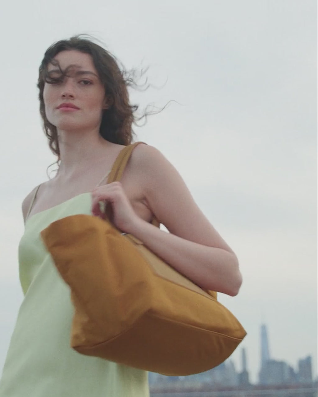 A video featuring a model walking through the city while carrying the Vee TA Anderson collaboration bag.