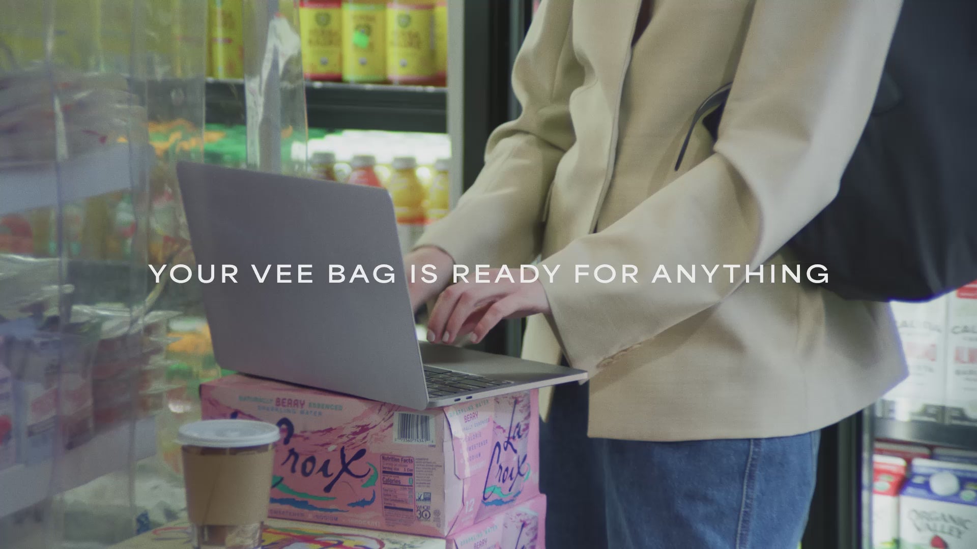 A video featuring a model in a supermarket, carrying an Essence City Tote Black while answering a phone.