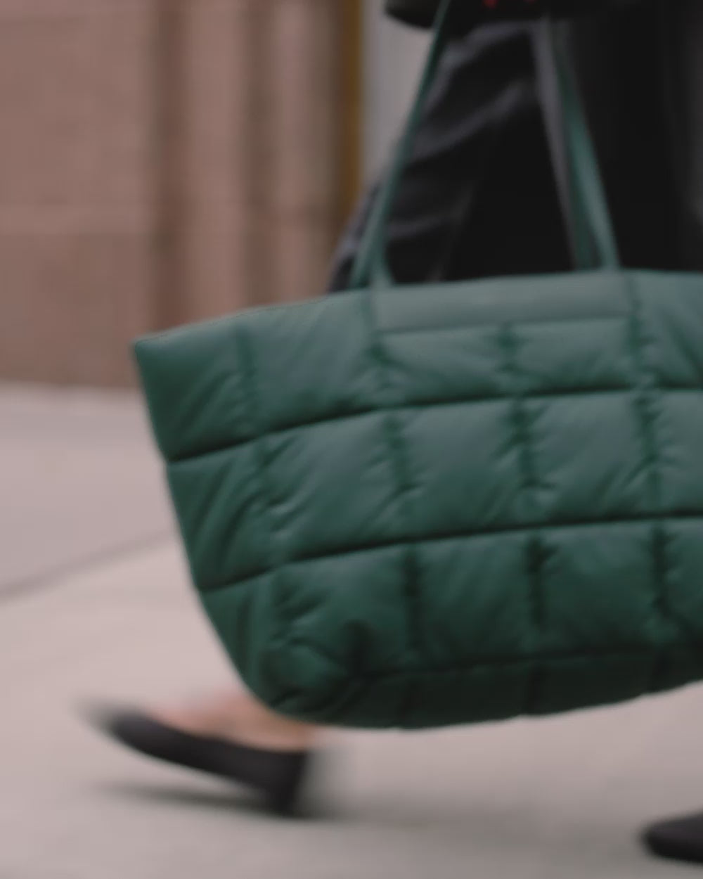 Video showing lower half of a woman walking with the Porter Marché Bottle Green shoulder bag.