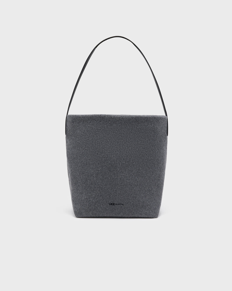 A dark gray felt shoulder bag with a slim black leather strap, shown against a light gray background.