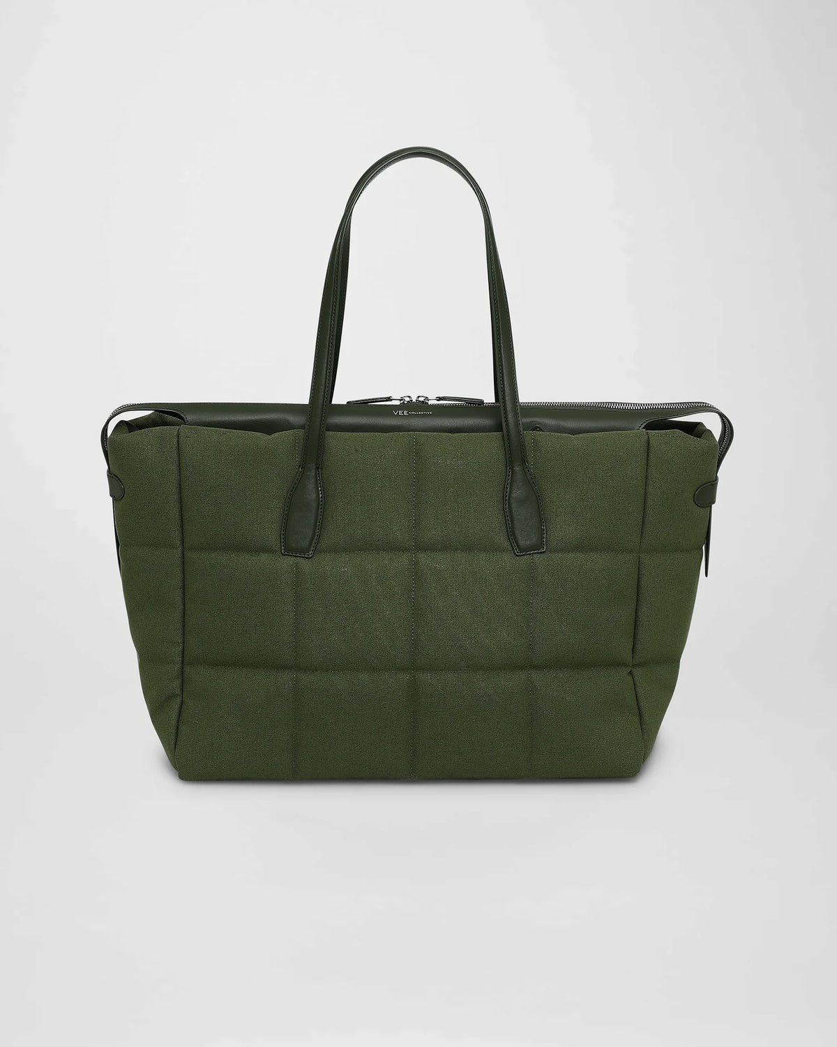 A picture featuring the front view of a medium Tela Tote Bag in olive with leather handles, displayed on a white background.