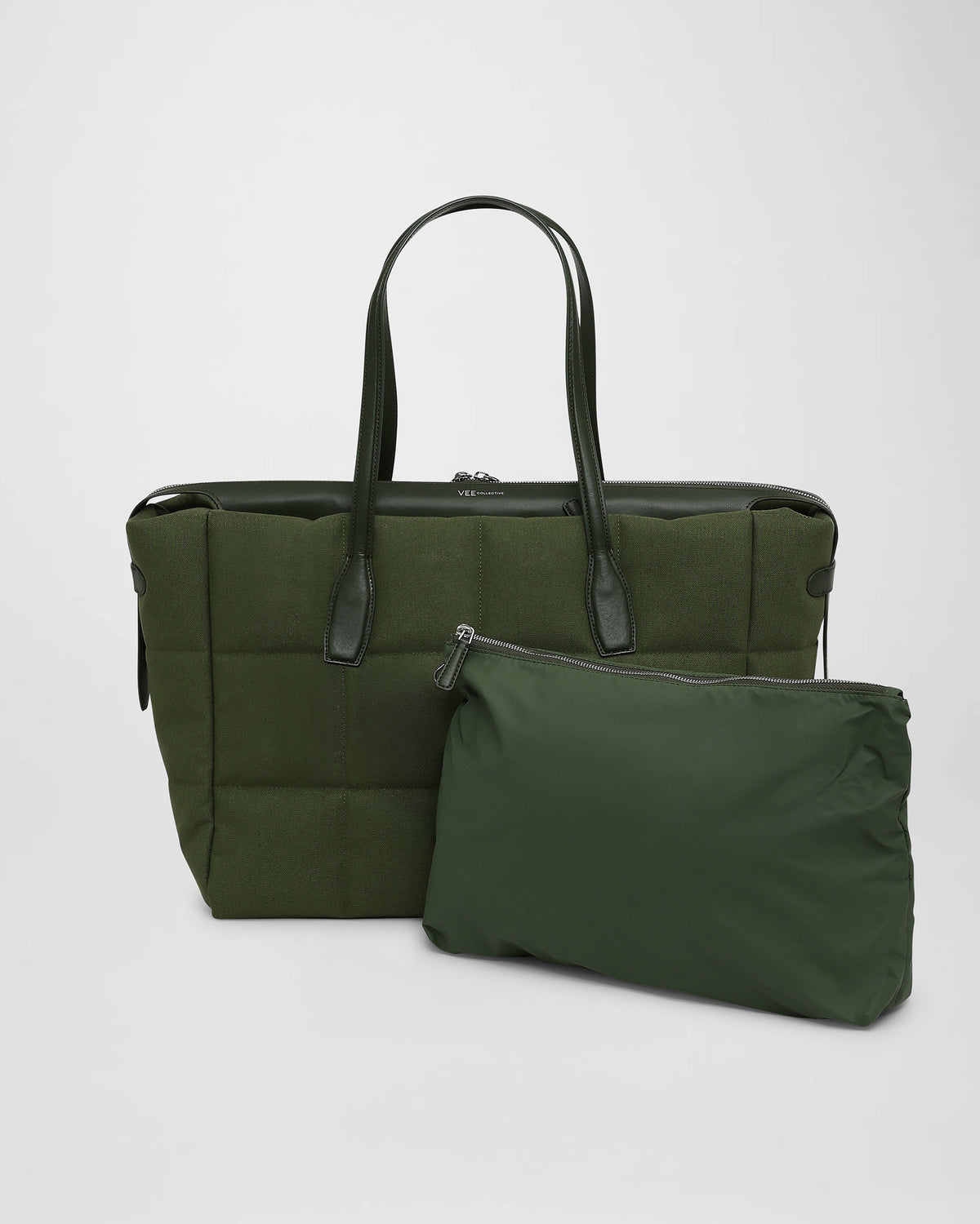 A picture featuring a Tela Tote Bag in apple green with dark green leather handles, shown alongside a matching olive green zippered pouch on a white background.