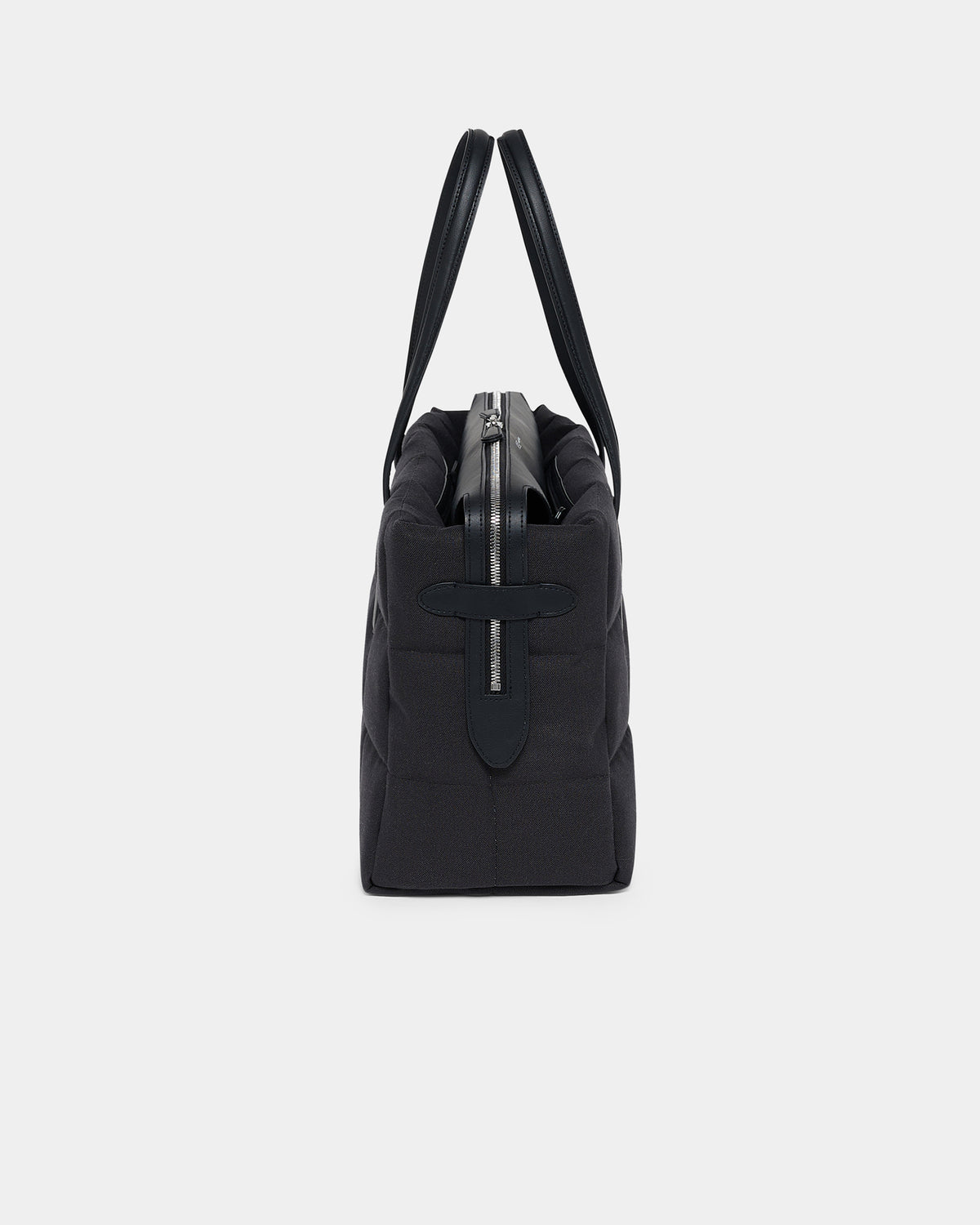 A photo of a Tela Tote Shoulder Bag featuring a silver-tone metal zipper and a black leather cross detail on the front, shown from a rear three-quarter view against a plain white background.