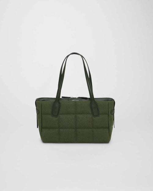 A photo of a Tela Tote featuring black leather handles and trim, displayed against a plain white background. size_picker