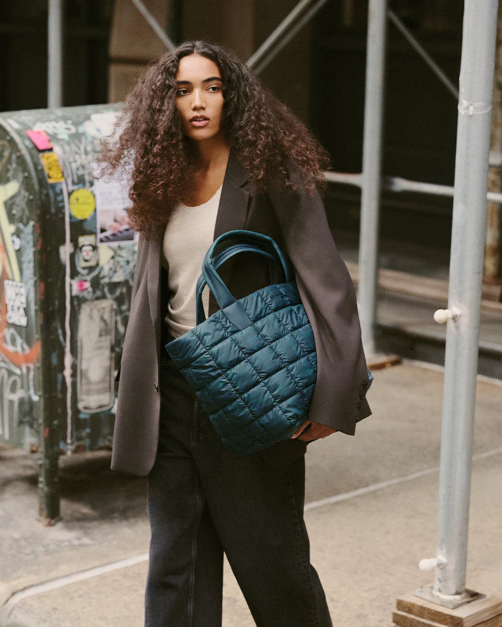 On-body shot of a woman holding the Porter Tote Bag Medium in Ivy Plaid under her arm.