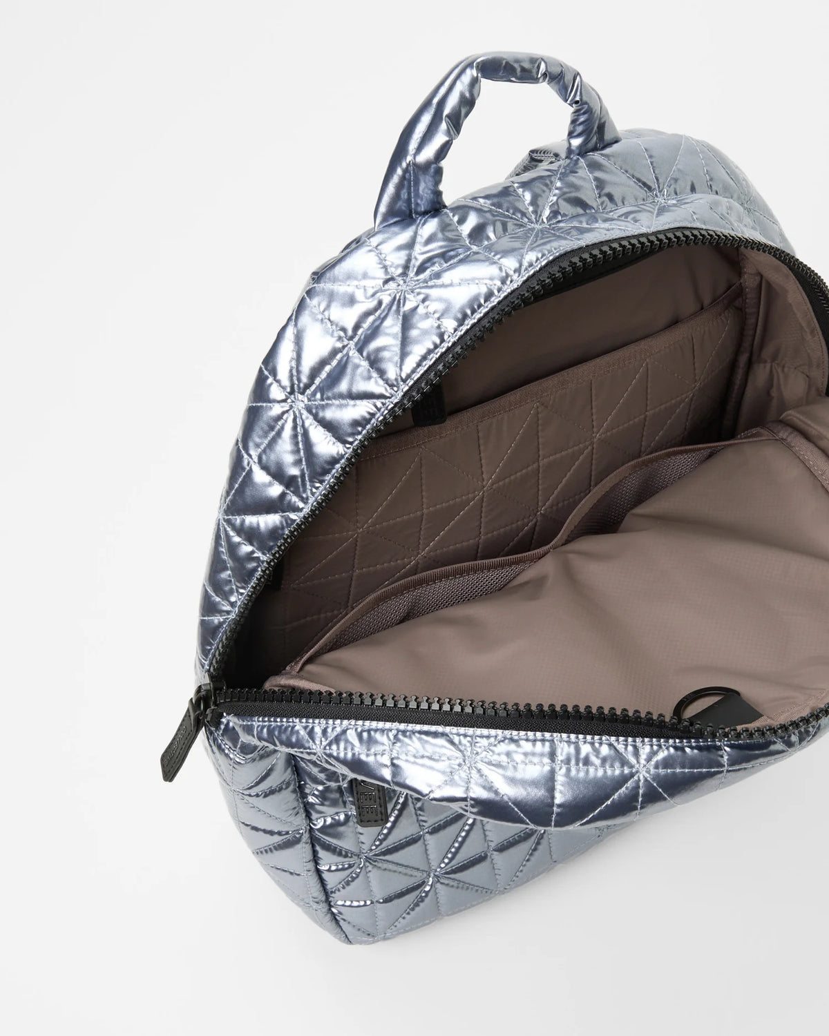Open Vee Collective Vee Backpack in Icy Silver, showing the quilted exterior, top zipper, and interior compartments of the tote bag.