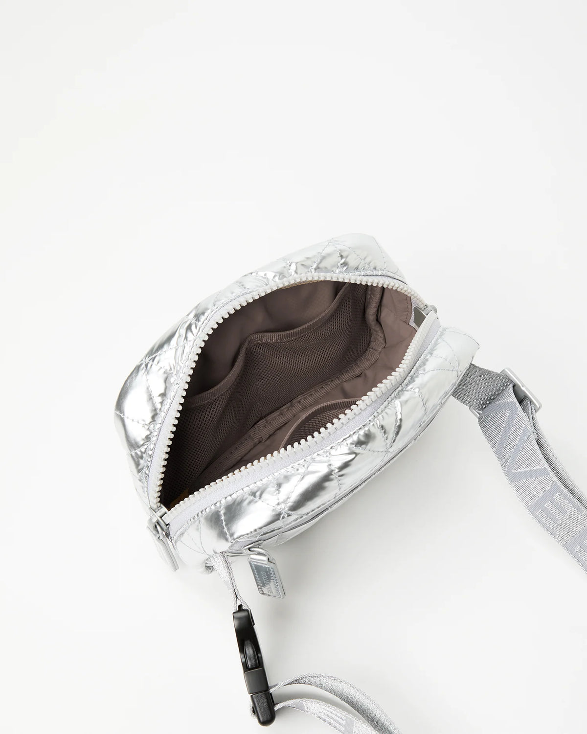 Close-up of a silver belt bag with a 
broen interior lining 
