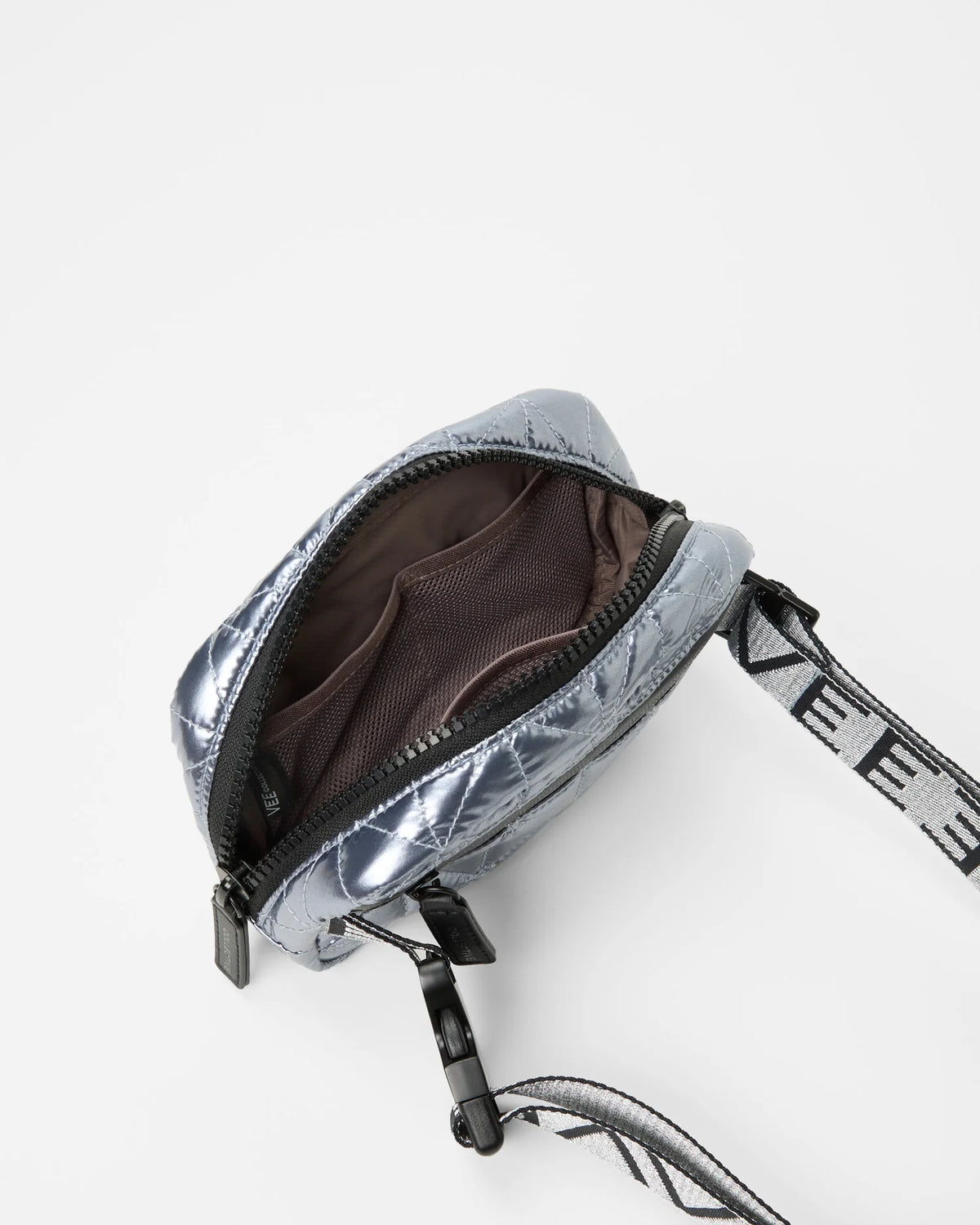 Open Vee Collective Vee Belt Bag in Icy Silver, showing the quilted exterior, top zipper, and interior compartments of the tote bag.