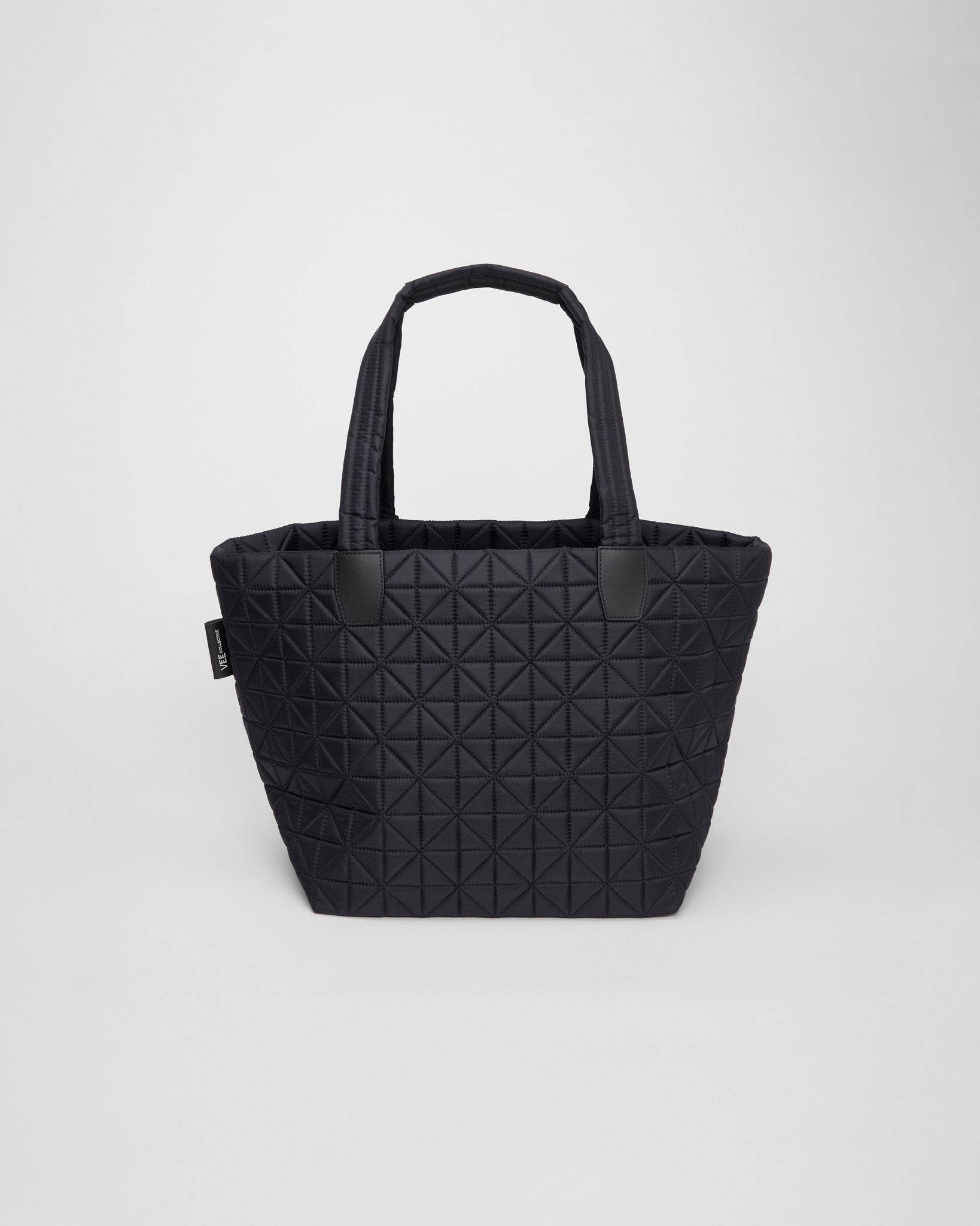 Large black tote bag crafted from lightweight, sustainable, and waterproof materials. Designed for versatility, it’s perfect for  gym sessions, busy moms, work, and travel. Combines stylish design with practical durability for everyday convenience.