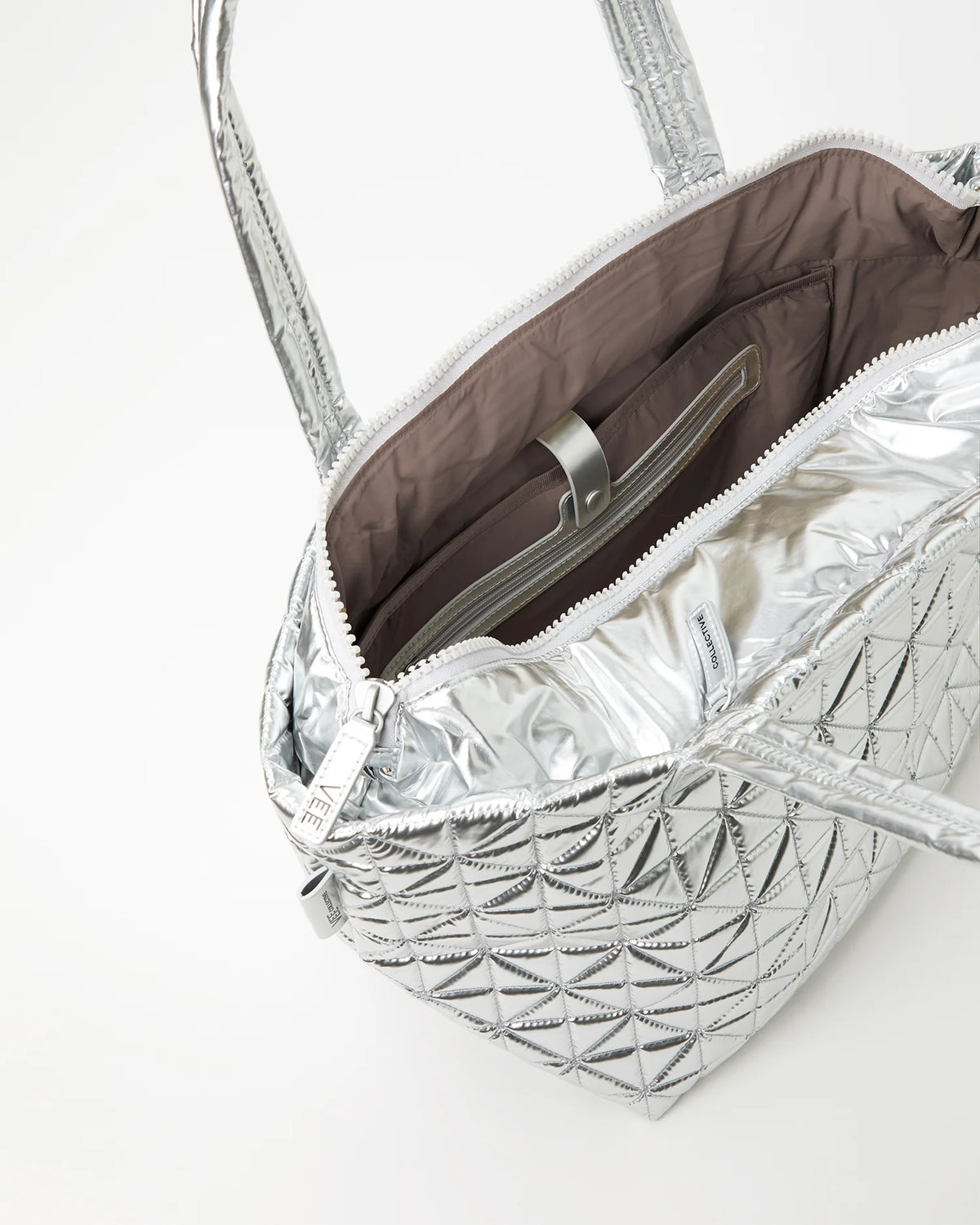 Silver quilted handbag with a brown interior on a white background
