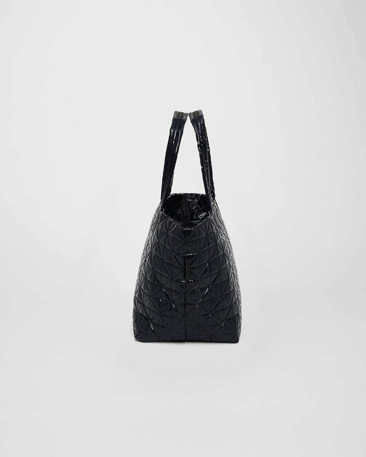 A medium-sized tote bag in a sleek, quilted black vinyl design features geometric stitching and two sturdy handles. Its modern shape and versatile style make it suitable for various activities, from work to leisure.