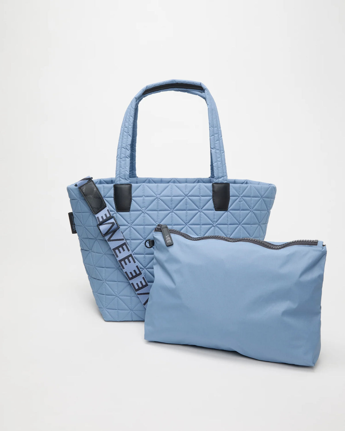 Front view of the Vee Tote Bag Medium in Pigeon Blue, shown with its matching pouch and detachable strap.