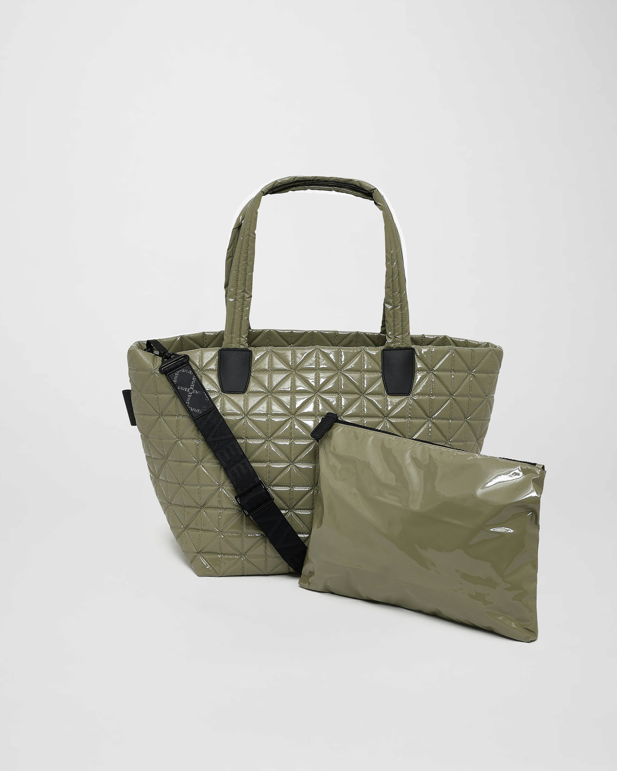 A medium sage green tote bag with a quilted triangle design and geometric stitching is displayed alongside a matching zippered pouch.