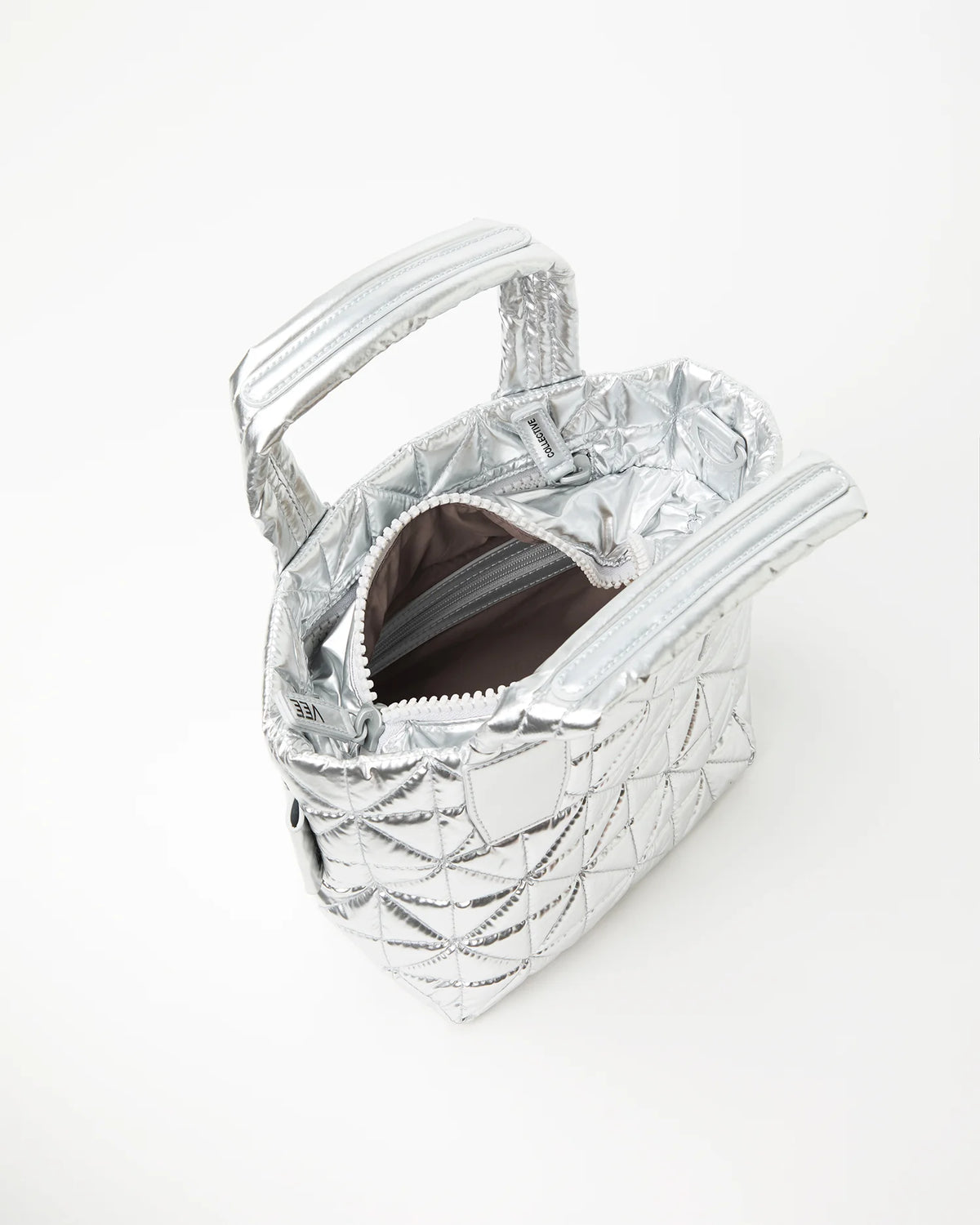Silver quilted handbag with brown interior on a white background
