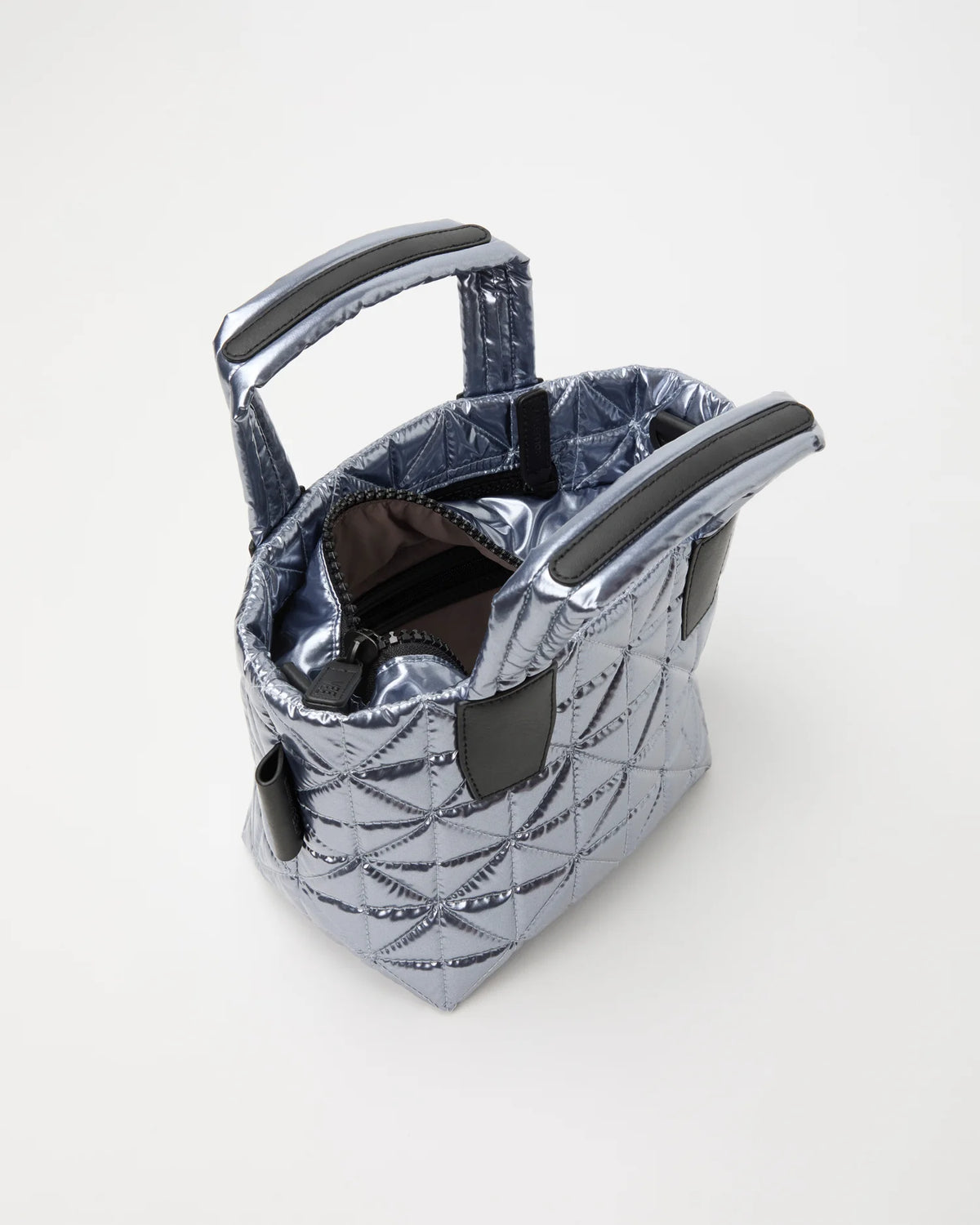 Open Vee Collective Vee Tote Mini in Icy Silver, showing the quilted exterior, top zipper, and interior compartments of the tote bag.