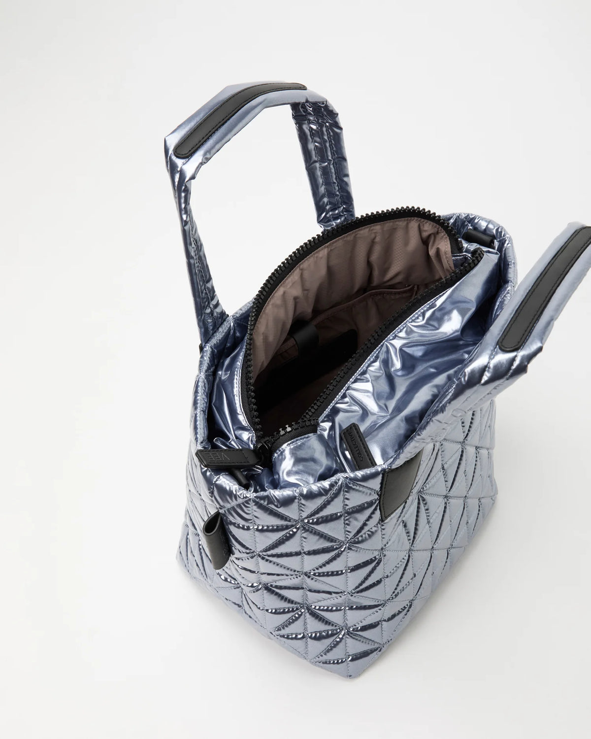 Open Vee Collective Vee Tote Small in Icy Silver, showing the quilted exterior, top zipper, and interior compartments of the tote bag.
